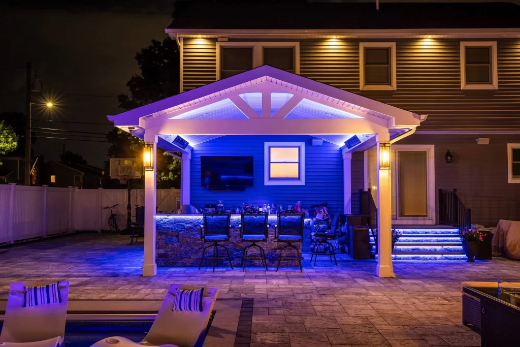 A backyard with a gazebo and patio lights.