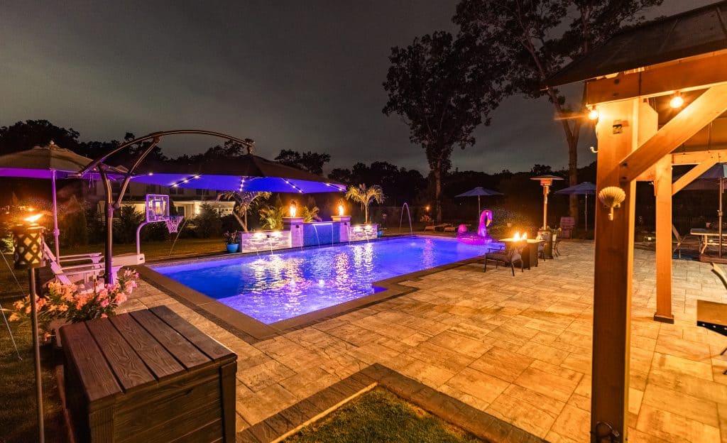 view of custom pool completed at night.