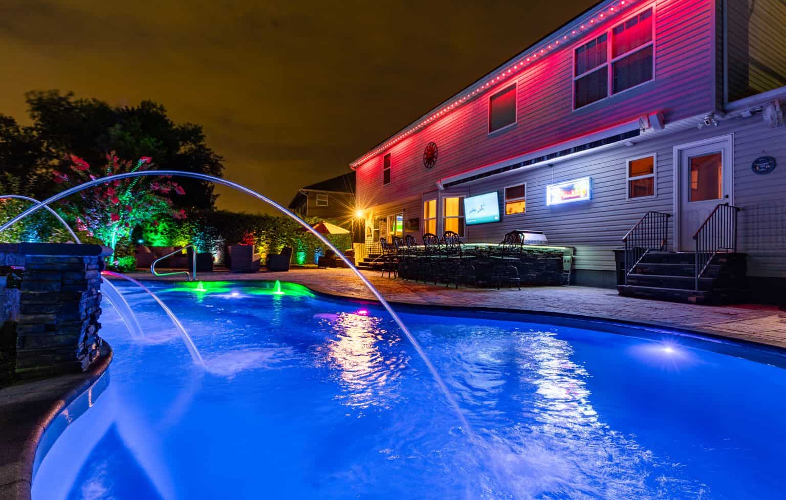 pool and backyard at dusk with ambient lighting.