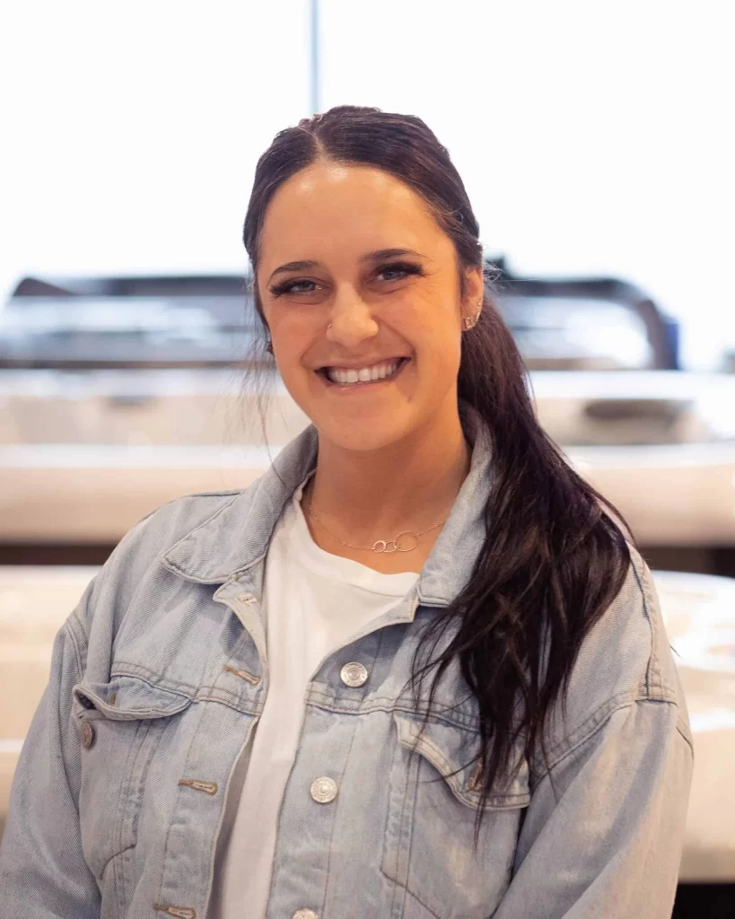 Cassandra Russo, General Manager of a Long Island pool company, standing confidently in a professional setting&mdash;representing leadership in custom pool design, operations, and client service